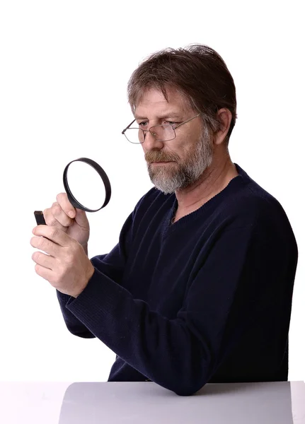 Man with the magnifying glass in hand — Stock Photo, Image