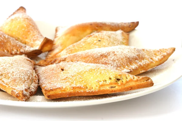 Sweet baked pastry triangles filled with nuts — Stock Photo, Image