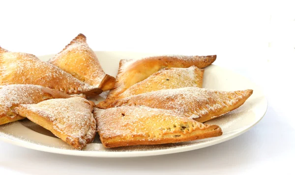 Sweet baked pastry triangles filled with nuts — Stock Photo, Image