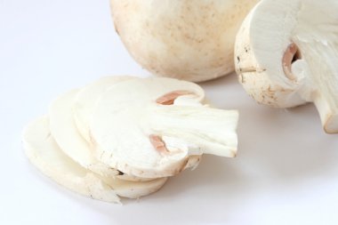 Cut raw mushrooms agarics on grey background