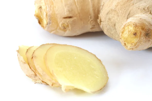 Whole ginger root and slices on white backgroundg Royalty Free Stock Images