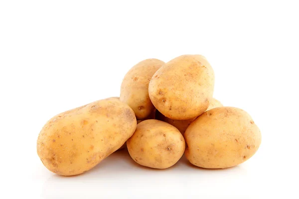 Stacked unpeeled potatoes — Stock Photo, Image