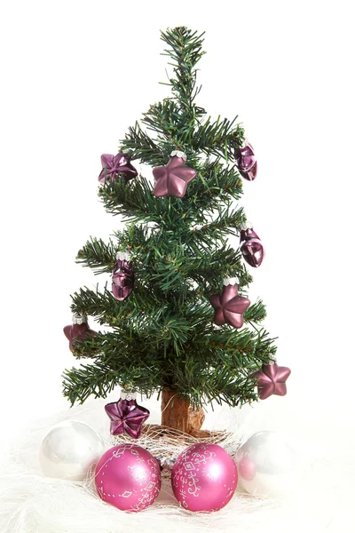 Plastic kerstboom met paarse sterren — Stockfoto