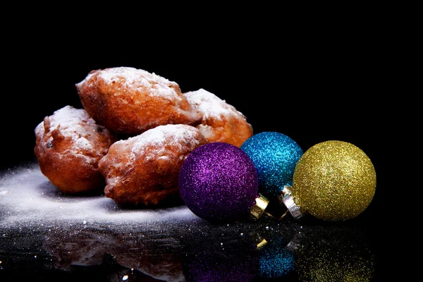 Pile of Dutch oliebollen and Christmas balls — Stock Photo, Image