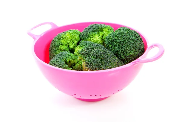 Pink colander with broccoli vegetable — Stock Photo, Image