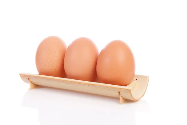 Three chicken eggs in a row — Stock Photo, Image
