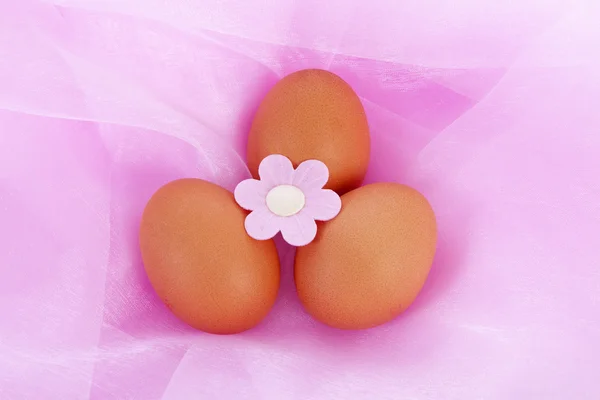 Easter chicken eggs on pink fabric — Stock Photo, Image