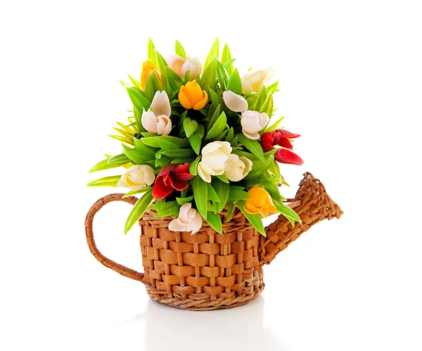 Cane watering can with plastic Dutch tulips — Stock Photo, Image