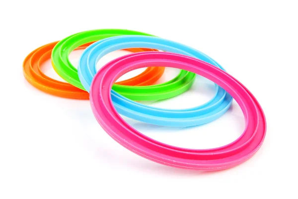 Quatro anéis de plástico coloridos — Fotografia de Stock