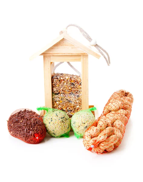 Wooden bird feeder house with food — Stock Photo, Image
