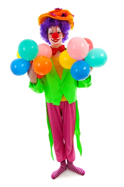 Ребенок, одетый как красочный смешной клоун с воздушными шарами — стоковое фото