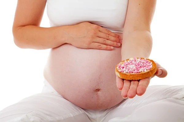 Pregnant belly with pink mice on rusk — Stock Photo, Image