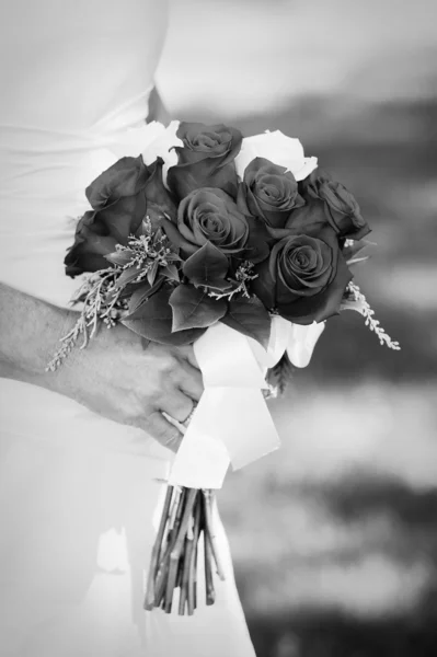 Nevěsta drží červené růže kytice — Stock fotografie