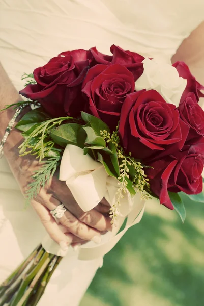 Mariée tenant bouquet de roses rouges — Photo
