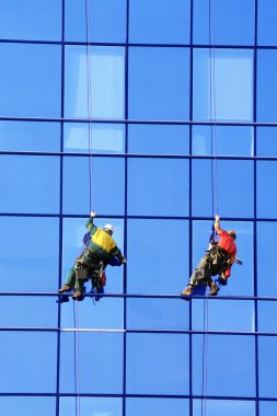 Group of washers wash the glass facade clipart