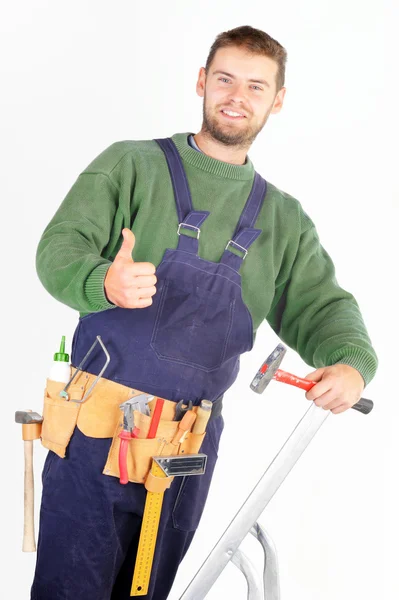 Real handsome carpenter standing on a ladder — Stock Photo, Image
