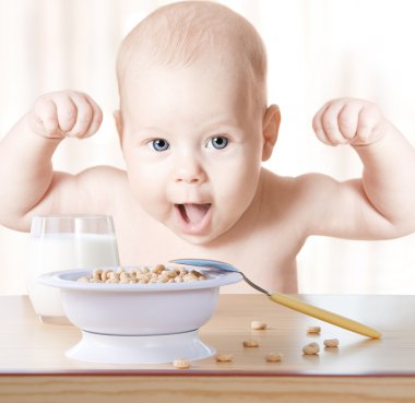 Happy baby meal: cereal and milk. Concept: healthy food makes ch clipart