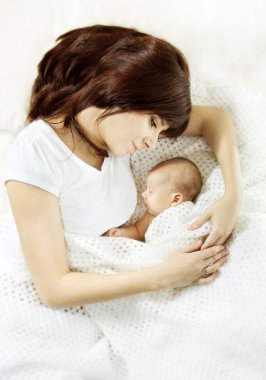 Mother embracing sleeping newborn baby clipart