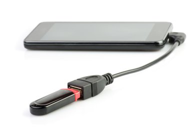 Mobile phone in which a computer flash drive is inserted. clipart