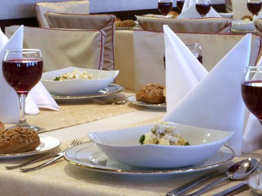 Served table with red wine at restaurant clipart