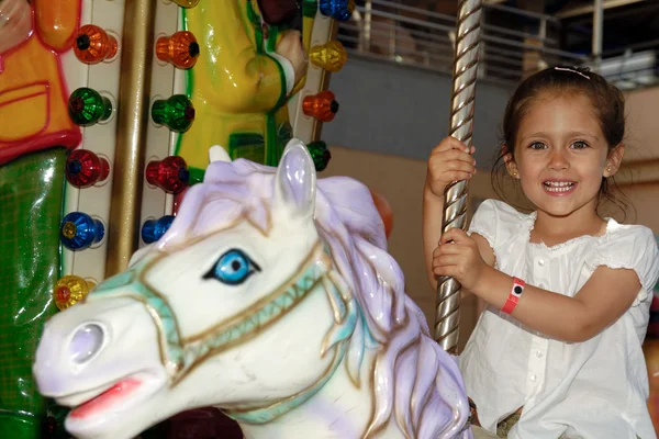 Child in carousel — Stock Photo, Image