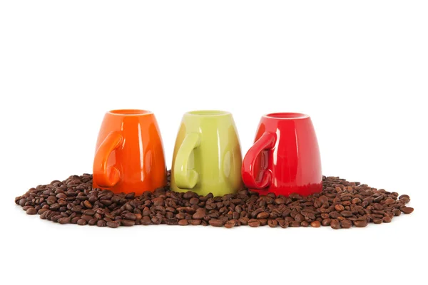 Colorful coffee mugs with beans — Stock Photo, Image