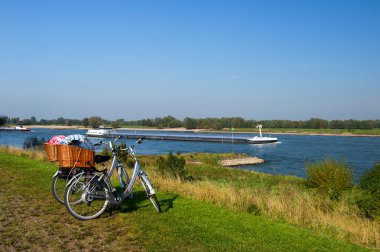 Dutch river landscape with bicycles clipart