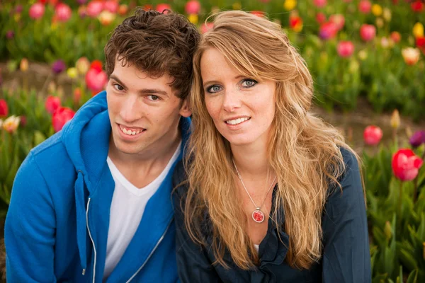 Young couple in Dutch flower fields — Stock Photo, Image