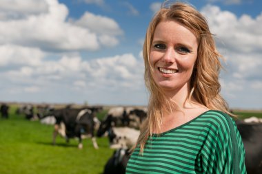 Dutch girl in field with cows clipart