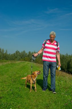 Walking the dog in nature clipart