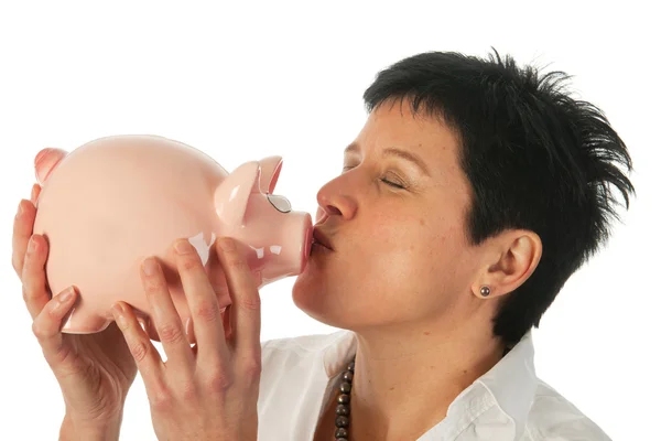 Young woman kissing piggy bank — Stock Photo, Image