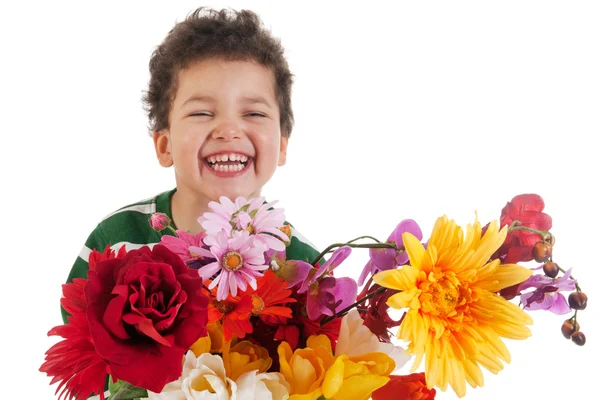 Skrattande pojke med blommor — Stockfoto