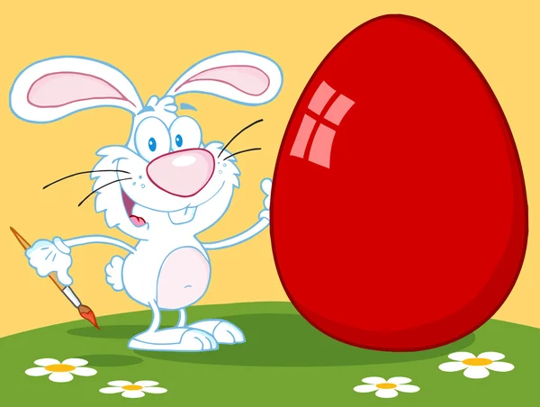 Happy Rabbit Painting Red Easter Egg Outdoors — Stock Photo, Image
