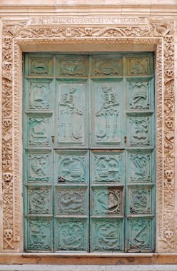 Antique door decorated with skulls and skeletons clipart