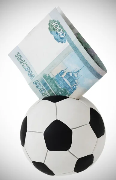 stock image Thousand rubles going into football money box