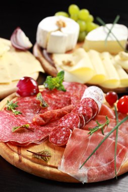 Salami and cheese platter with herbs clipart