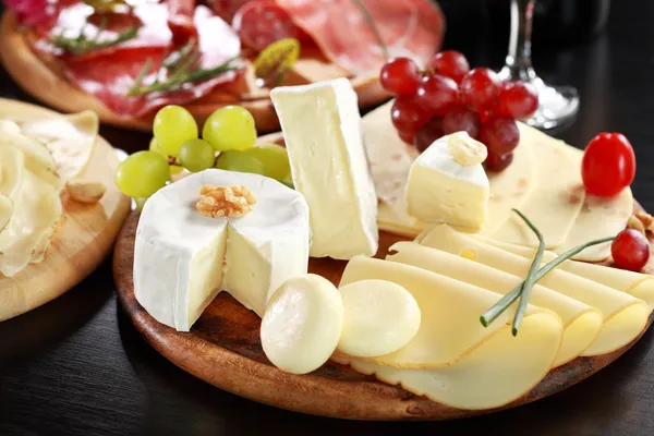 Cheese and salami platter with herbs — Stock Photo, Image