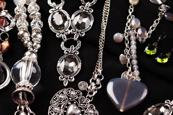 Necklaces and accessories on black background