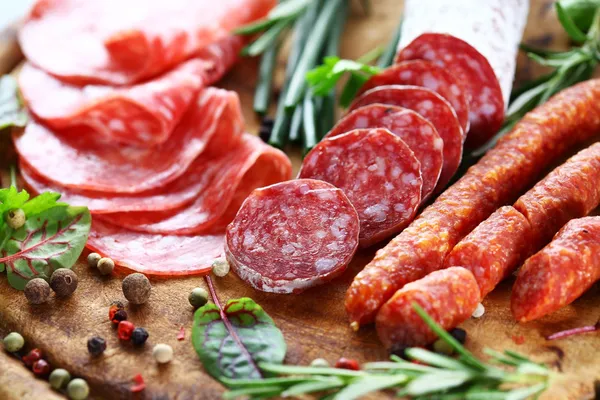 Italian ham and salami with herbs — Stock Photo, Image