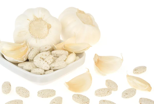 Garlic and herbal supplement pills isolated, alternative medicine concept Stock Photo