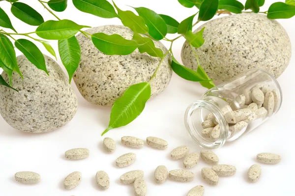 Herbal supplement pills spilling out of bottle – alternative medicine conce — Stock Photo, Image