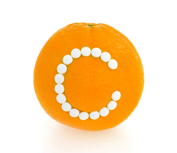 Orange with vitamin c pills over white background - concept — Stock Photo, Image