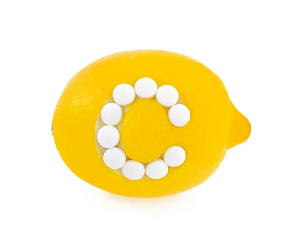 Citron avec des pilules de vitamine c sur fond blanc - concept — Photo