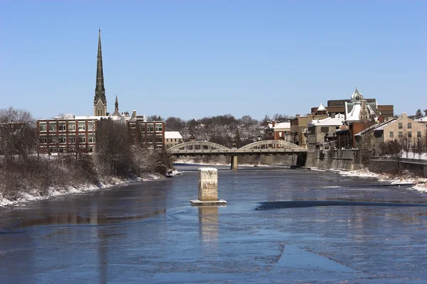 stock image Old town with bridge over a river on a sunny winter day.