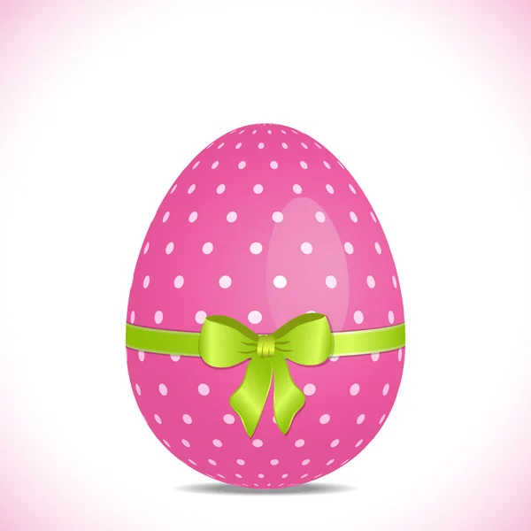 Pink polka dot easter egg with green ribbon — Stock Vector