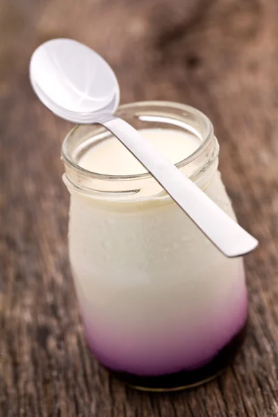Yogurt in glass jar — Stock Photo, Image