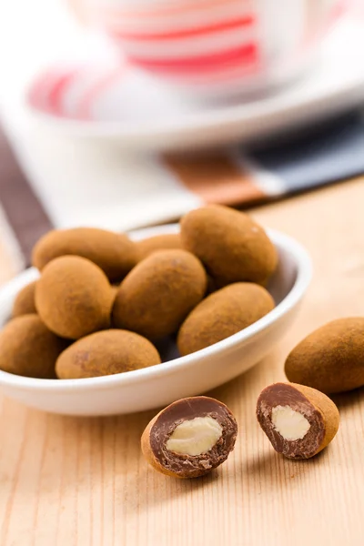 Almonds in chocolate with cinnamon — Stock Photo, Image