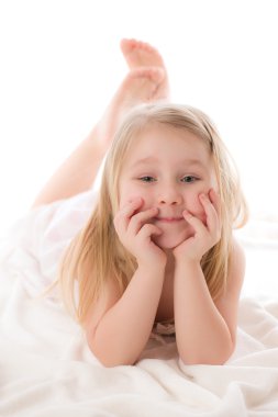 Young girl lying on floor in studio clipart