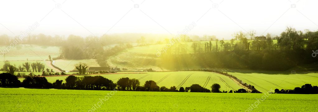 English landscape panamoric view across fields with sunrise