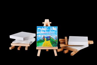 Artists easels stacked on a black background clipart